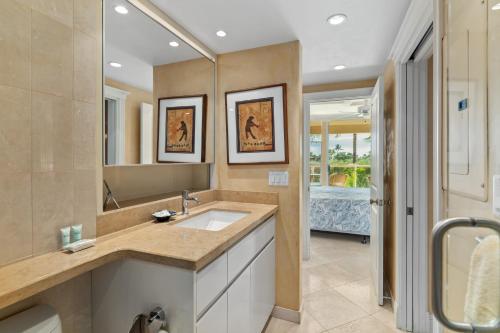 a bathroom with a sink and a large mirror at Beautiful central kihei two bedroom (MBG309) in Wailea