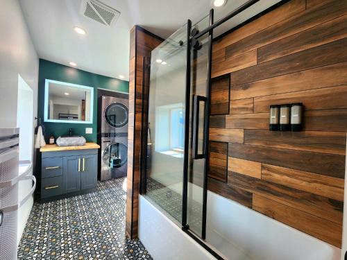 a bathroom with a shower with wood paneling at Peaceful City View - Hot Tub - 2 Parking & EV Chrger in Quebec City