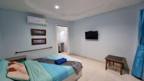 a bedroom with a bed and a tv on the wall at HappyLove1 in Ko Larn
