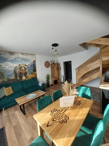 a living room with a couch and a table at Gorczański Resort Domek w Górach Sauna Jacuzzi in Nowy Targ
