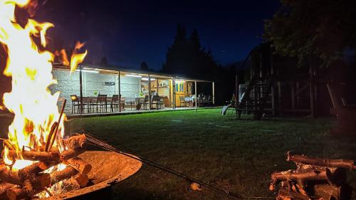 a fire pit in front of a house at night at PENZION BLANKA - Znojmo in Znojmo