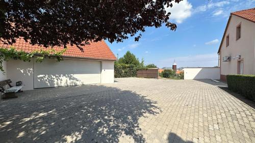 a parking lot with a garage and a building at PENZION BLANKA - Znojmo in Znojmo