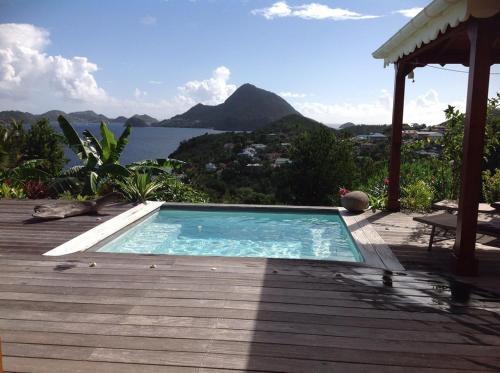 a swimming pool on a deck with a view of the water at villa Kabri terre de bas in Terre-de-Bas