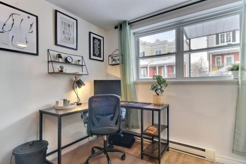 an office with a desk and a chair and a window at Enchanting Loft - Fireplace AC Quebec Downtown in Quebec City