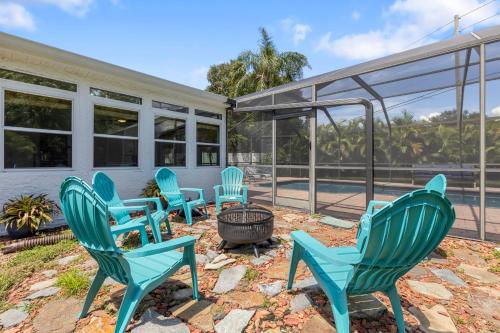 a group of blue chairs sitting on a patio at Relaxing Coastal Comfort - Heated Pool in Clearwater
