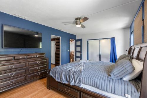 a bedroom with a large bed and a tv at Relaxing Coastal Comfort - Heated Pool in Clearwater