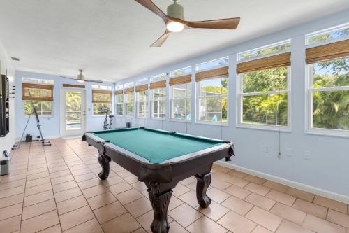 a pool table in a room with windows at Relaxing Coastal Comfort - Heated Pool in Clearwater