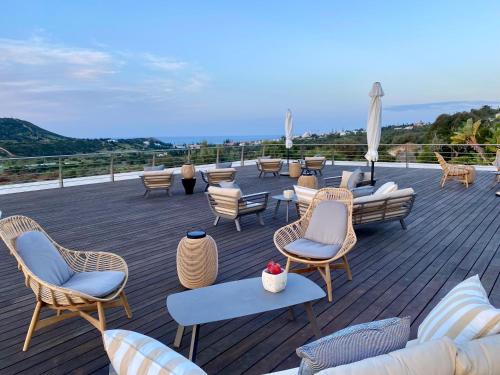 a group of chairs and tables on a deck at Vila Valverde Design Country Hotel in Luz