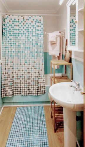 a bathroom with a shower curtain and a sink at Días de Sur in Santander