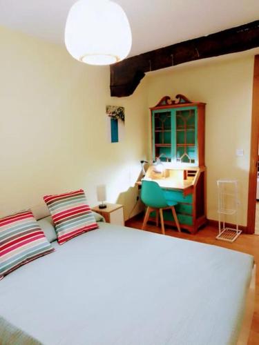 a bedroom with a bed and a desk and a sink at Días de Sur in Santander