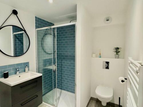 une salle de bain avec toilettes, lavabo et miroir dans l'établissement Au Cœur des Moissons, à Reims