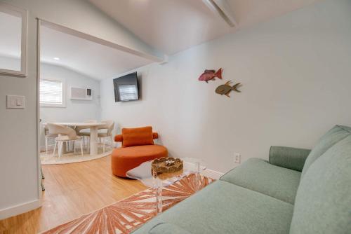 a living room with a couch and a table at New The Cottage at James House in Key West