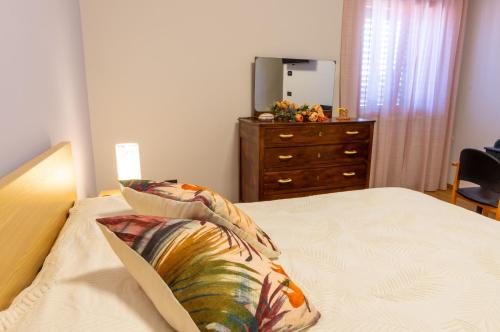 a bedroom with a bed with a dresser and a dresser at San Lorenzo B & B in Ruoti