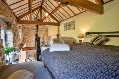 a bedroom with a large bed in a room at Finest Retreats - End Barn at Blackclough Farm in Buxton