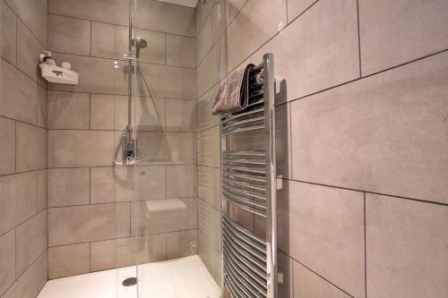 a bathroom with a walk in shower with a shower at Finest Retreats - End Barn at Blackclough Farm in Buxton