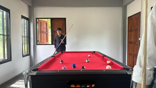a man standing in front of a pool table at JJ and J Garden1 Pai in Pai