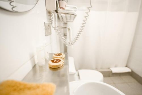 two donuts sitting on a counter in a bathroom at Hotel Raymi in Cusco