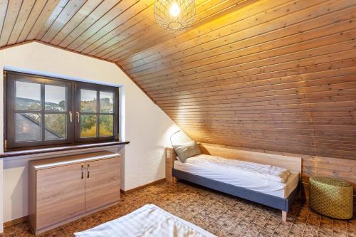 a small room with a bed and a window at Azalea in Olsberg