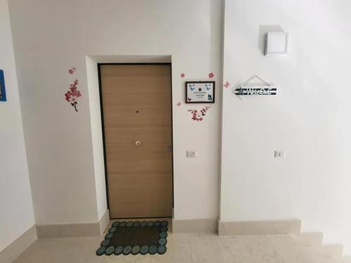 a hallway with a door and a clock on the wall at Spacious Apartment in Balestrate 70 m² with Balcony in Balestrate