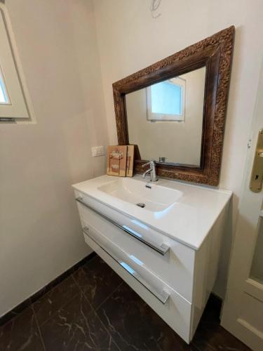 a bathroom with a white sink and a mirror at Comfortable apartment in Castell'Arquato of 80 m² in CastellʼArquato