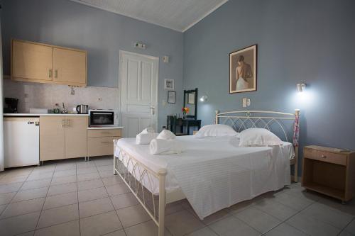 a bedroom with a large bed and a kitchen at Panorama in Lixouri