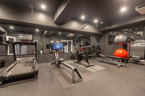 a gym with several exercise equipment in a room at The Maverick, powered by Placemakr - River Walk in San Antonio