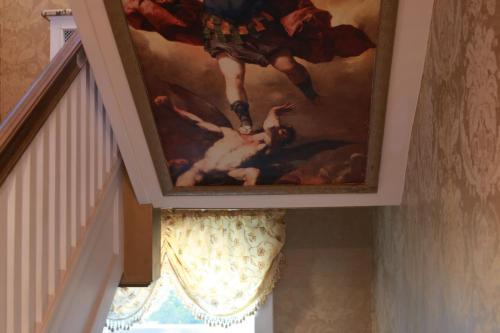 a painting on the ceiling of a stairway at Chateau Connellsville Art Deco Suite in Connellsville