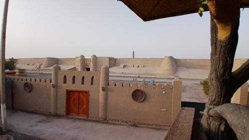 a model of a building with a red door at Deshon Qala Guest House in Khiva