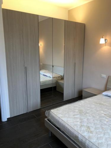 a bedroom with a bed and a mirrored cabinet at Happy Haven al mare in Chiavari