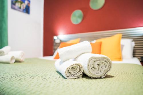 a pile of towels sitting on a bed at Dodo's house in Bari