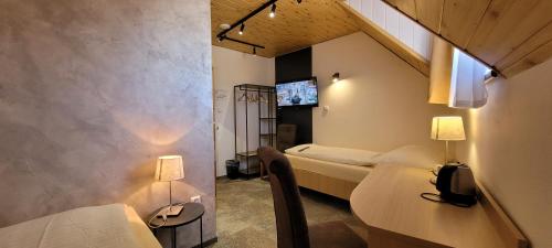 a room with two beds and two tables and two lamps at Ferdinand Penzion in Moldava nad Bodvou