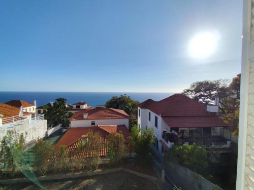 a view of houses and the ocean from a building at Sea House in Funchal