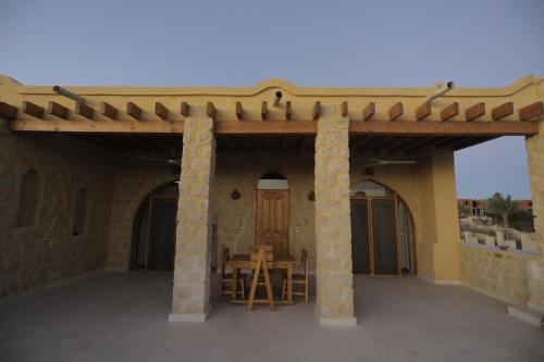 a patio of a house with a wooden roof at Hoopoe lodge in Tunis
