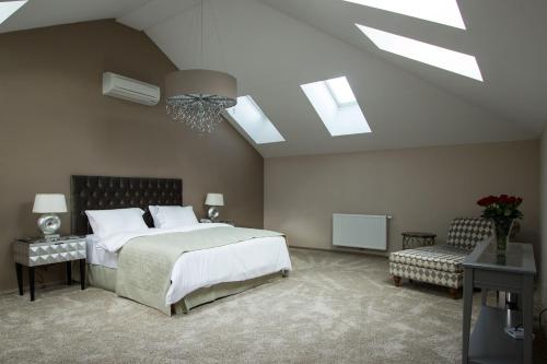 ein Schlafzimmer mit einem großen Bett und einer Decke mit Oberlichtern in der Unterkunft Vienna Suites in Wien