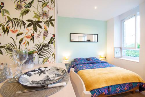 una camera con un letto e un tavolo con piatti di Le Paisible I Centre ville & Quartier calme a Brest