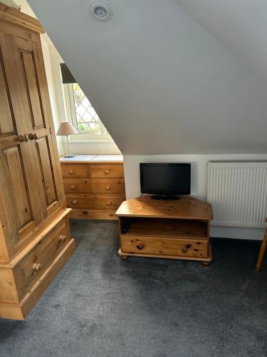 a living room with a tv on a wooden table at Ragged Hall Lane in St. Albans