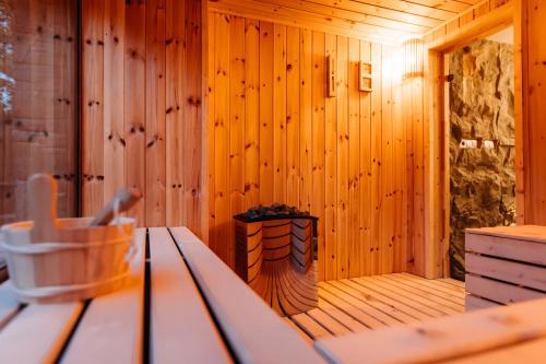 a wooden sauna with a bench in a room at Grand Chalet Lacu Rosu in Lacu Rosu
