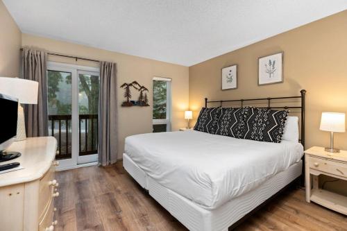 a bedroom with a bed and a desk and a television at Highlands 05 with Wintergreen Advantage in Wintergreen