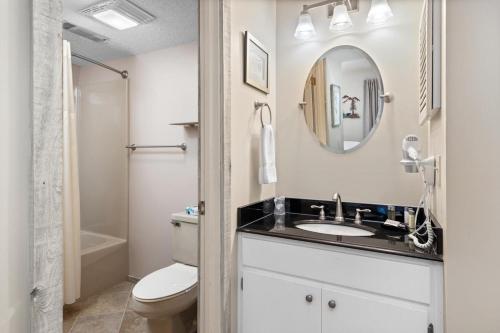 a bathroom with a sink and a toilet and a mirror at Highlands 05 with Wintergreen Advantage in Wintergreen