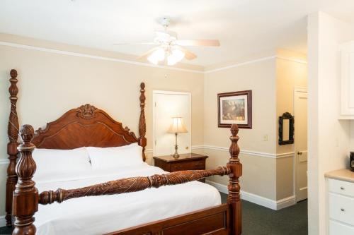 a bedroom with a bed and a ceiling fan at Lake Lure Inn and Spa in Lake Lure