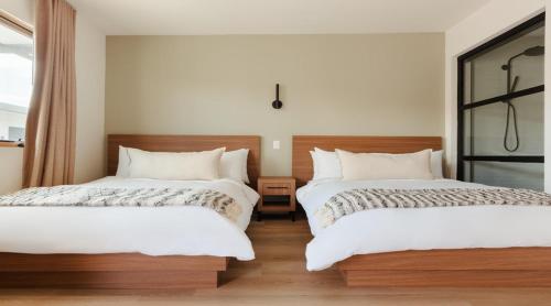 a bedroom with two beds and a window at The Lum Hotel Los Angeles Stadium District in Inglewood