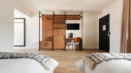 a bedroom with two beds and a desk at The Lum Hotel Los Angeles Stadium District in Inglewood
