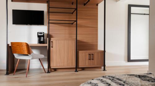 a bedroom with a desk and a tv and a chair at The Lum Hotel Los Angeles Stadium District in Inglewood