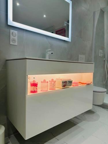 a bathroom with a sink and a toilet and a mirror at "Rose" Atypique, clim, coeur du Quartier Haut in Sète