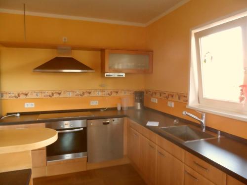 a kitchen with a sink and a window at Landhaus Bukenberger in Freudenstadt