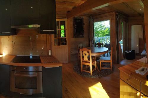a kitchen and dining area of a tiny house at Chalet au cœur du massif des Bauges in La Féclaz