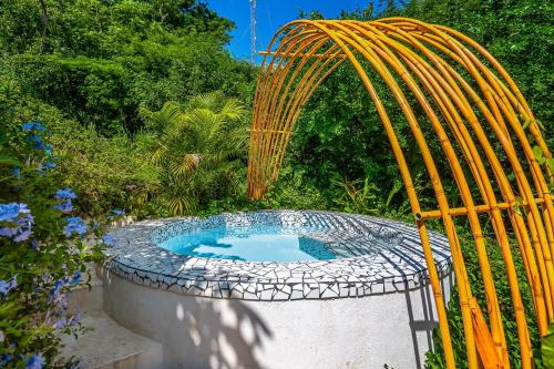 a circular pool with a yellow hose around it at Villa Heliconia in Barra de Navidad