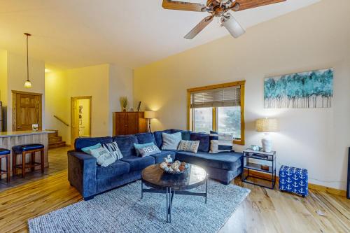 a living room with a blue couch and a table at Lake Minocqua Lakeview in Minocqua