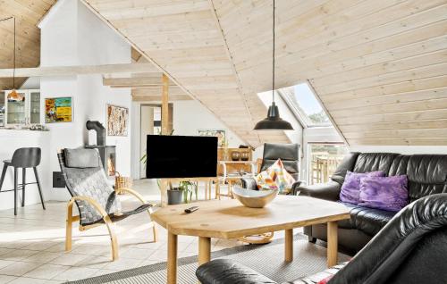 a living room with a couch and a table at Lovely Home In Ringkøbing With Sauna in Ringkøbing