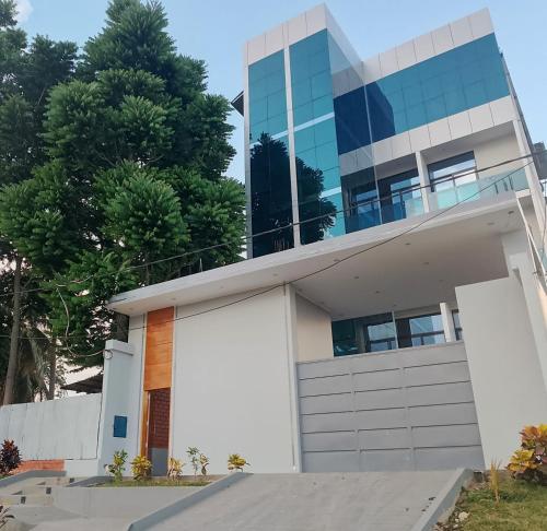 a house in front of a tall building at Hotel Vista Verde in Campoverde